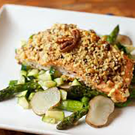 image of pecan chicken dish over salad